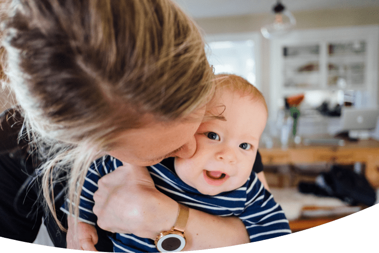 Mother hugging her laughing child